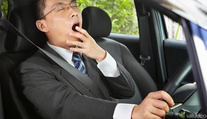 conductor asiatico formal conduciendo somnoliento